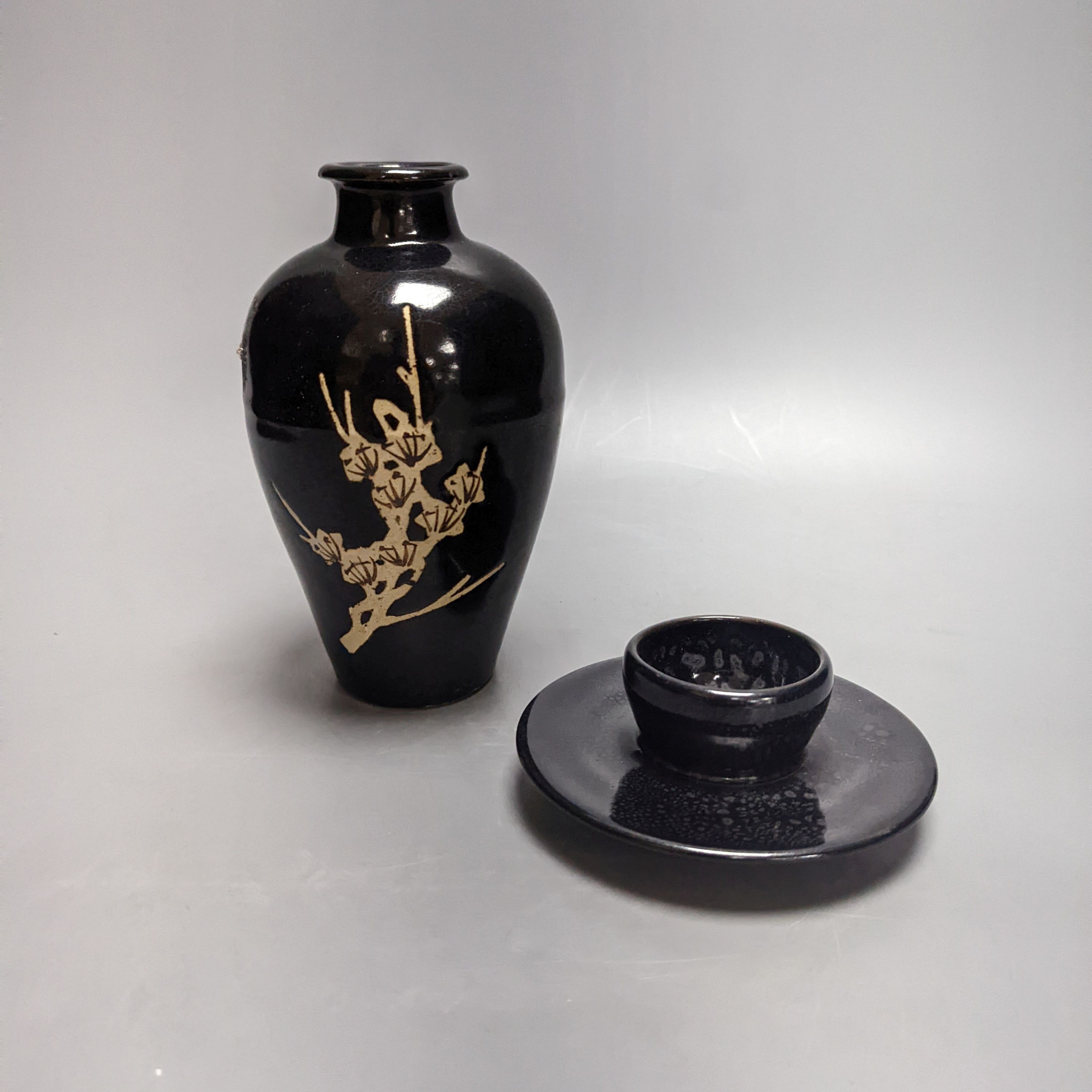 A Chinese oil spot glazed cup with integral stand and a black glazed resist pottery vase, 18cm